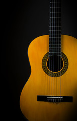 Naklejka na ściany i meble Acoustic guitar on black
