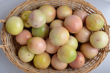 A basket of passion fruits on a white background