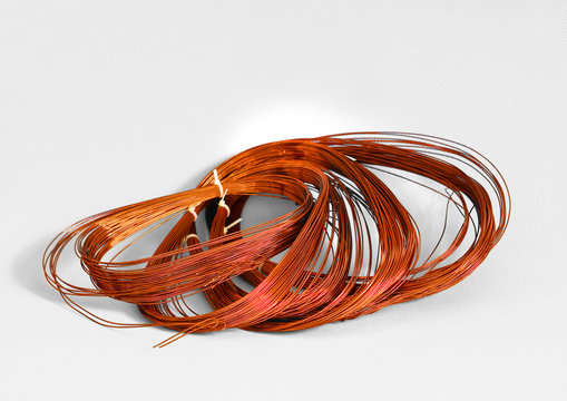 Skein cooper wire on white background. Copper wire winding, coil, spool section of the electric machine - generator or motor
