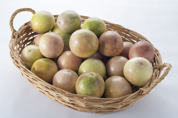 A basket of passion fruits on a white background