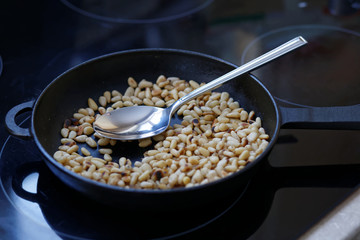 Pine nuts fried in a pan