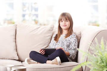 Obraz premium Adorable little girl with digital tablet