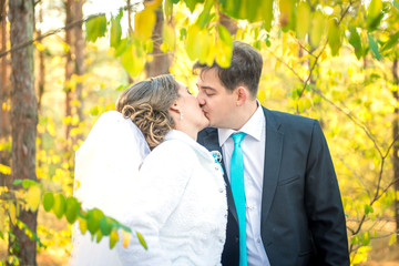 The bride and groom walk in the park