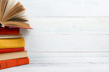 Open book, hardback books on wooden table. Back to school. Copy space