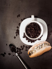 coffee cup with bread and coffe beans