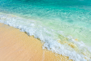 Soft wave of the turquoise sea on the sandy beach. Natural summe