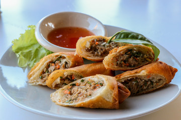 Fried vegetable spring rolls served with sweet chili sauce