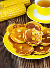 pancakes with corn on a yellow plate