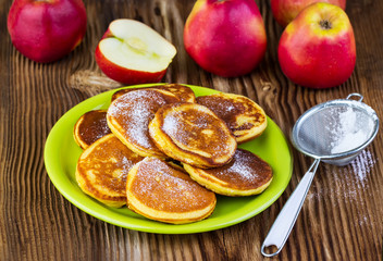 pancakes with apples on a green plate