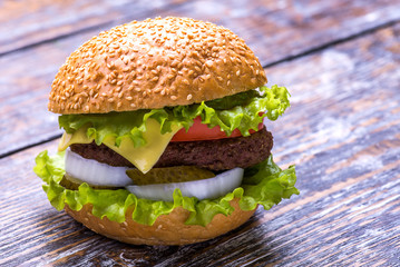 Big burger with beef cutlet and fresh vegetables isolated on white backgound