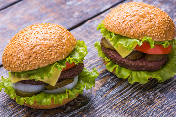 Big burger with beef cutlet and fresh vegetables isolated on white backgound