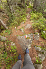 hiking alone long a small mountain path inside the forest
