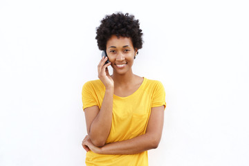 Smiling young african woman talking on cell phone