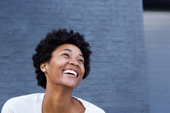 Smiling young african woman looking at copy space