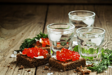 Cold Russian vodka with ice and small snacks sandwiches with but - obrazy, fototapety, plakaty