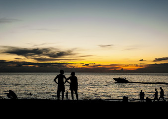 Fototapeta premium Silhouette people relax on the beach