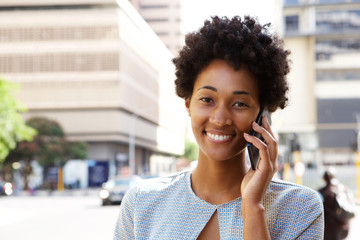 Happy young african woman talking on cellphone