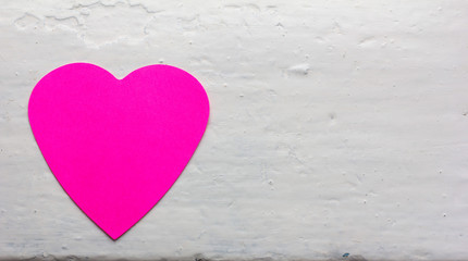 Fototapeta premium Valentine - paper heart magenta colors against the white painted surface. Copy space. Free space for text, Close-up, top view