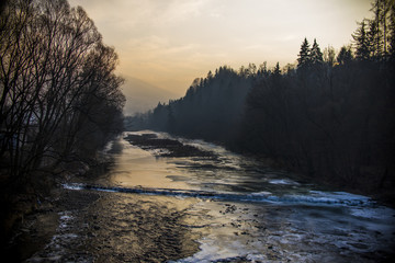 Sunset at a frozen river in the winter