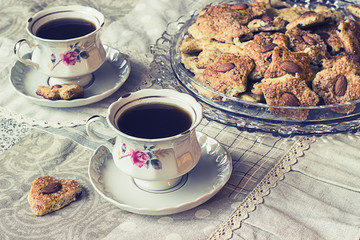 Two cups of coffe with cookies