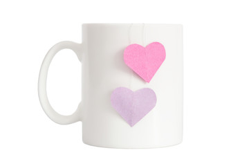Realistic classic white mug with heart shape labels isolated on white
