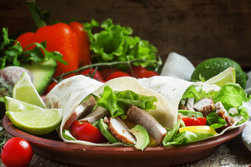 Fresh roll shawarma (doner) with meat, avocado, cherry tomatoes,
