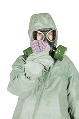 Man with protective mask and protective clothes holding out pill