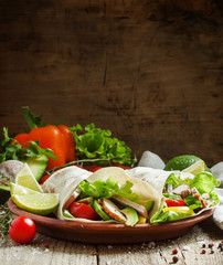 Fresh roll shawarma (doner) with meat, avocado, cherry tomatoes,