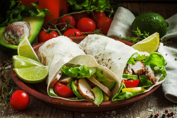 Fresh roll shawarma (doner) with meat, avocado, cherry tomatoes,