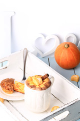 breakfast on a tray of coffee and pumpkin muffins selective soft focus rustic retro style