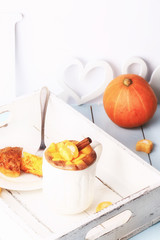 breakfast on a tray of coffee and pumpkin muffins selective soft focus rustic retro style