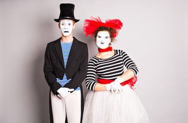 Waist-up portrait of funny mime couple with white faces. The concept of Valentine's Day, April...