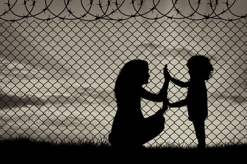 Silhouette of mother and child refugees