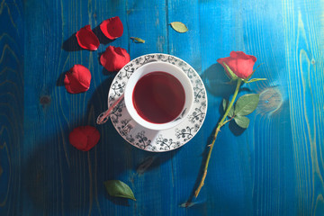 Obraz na płótnie Canvas cup of tea and red rose