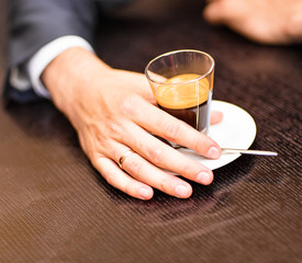 Man holds a cup of hot tea
