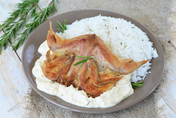 Quail with rice and creamy sauce and rosemary