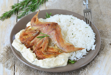 Quail with rice and creamy sauce and rosemary