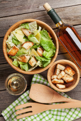 Fresh healthy caesar salad and white wine