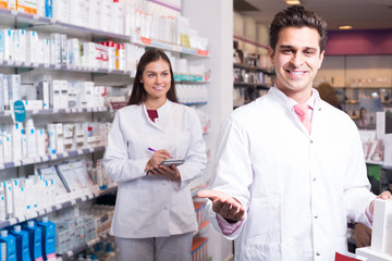 Obraz na płótnie Canvas team of pharmaceutist and technician working in chemist shop