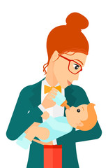 Obraz premium Woman feeding baby.