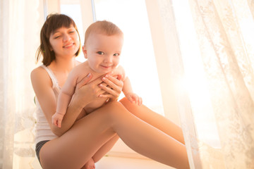 Young mother with her newborn baby - Powered by Adobe