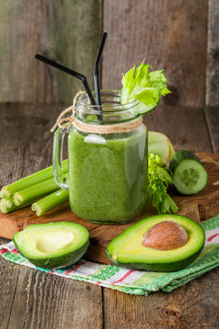 Healthy green juice smoothie with straw