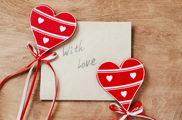 Card with Message With Love in the Letter and wooden red hearts