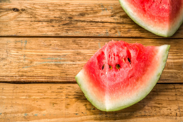 Slices of watermelon, background. Summer fruit on wooden planks