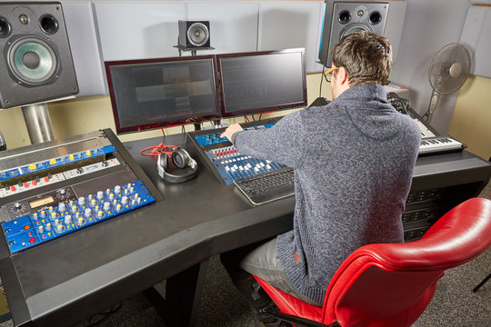 Sound studio technician preparing all settings on the mixing des