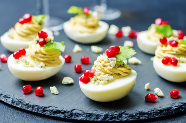 Blue cheese deviled eggs with pomegranate