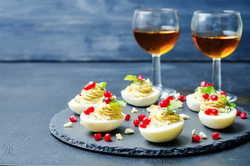 Blue cheese deviled eggs with pomegranate