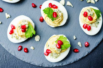 Blue cheese deviled eggs with pomegranate