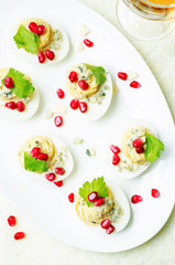 Blue cheese deviled eggs with pomegranate