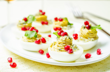 Blue cheese deviled eggs with pomegranate